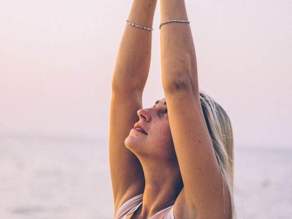 Silhouette of a person meditating at sunrise.