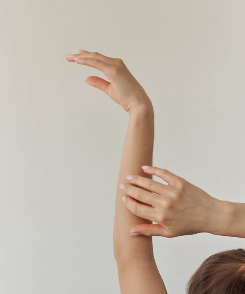 Woman in a graceful yoga pose with aquamarine light accents.